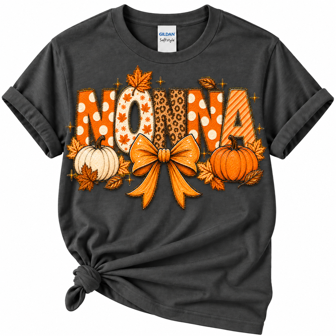 A dark charcoal gray Gildan Softee t-shirt with a rolled hem knot, featuring a large 'MOM' graphic in autumn colors with pumpkins, leaves, and a bow.